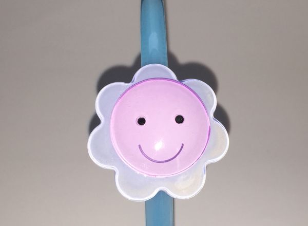 Head band with face patterned flower