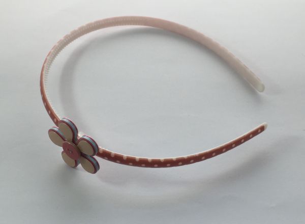 Polka dots patterned headband with flower shape